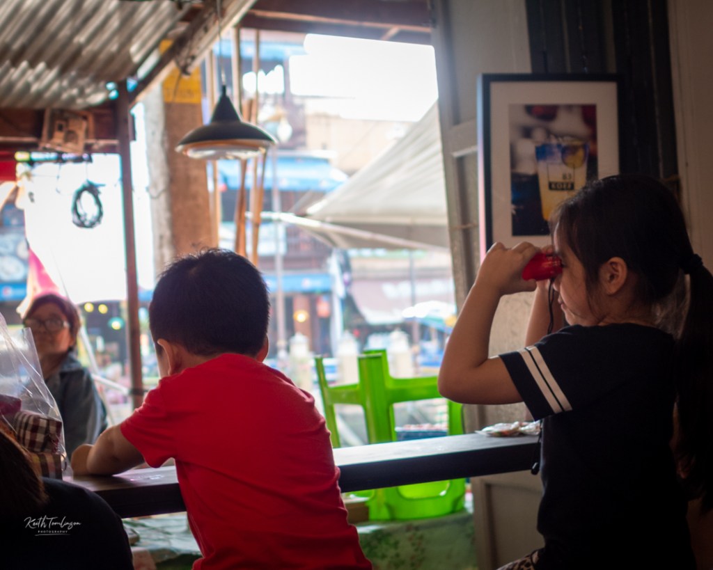 A Thai boy and girl enjoying a moment's peace in a coffee shop