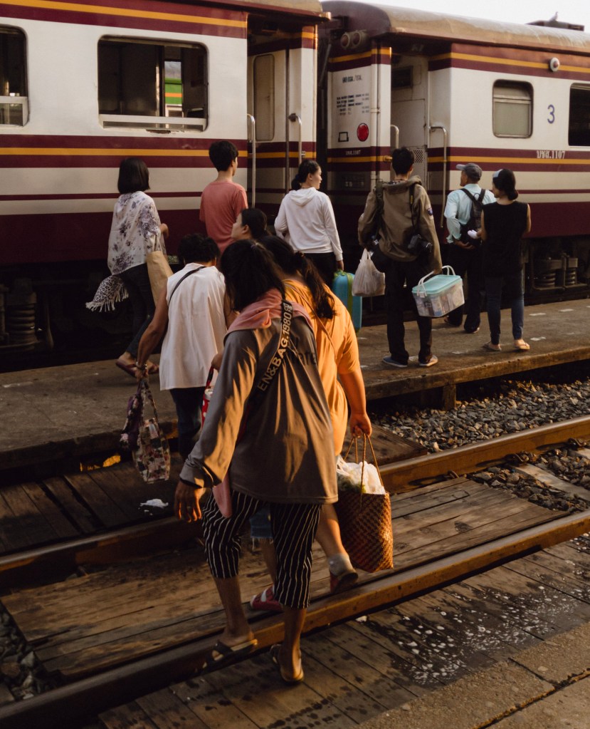 Thai people boarding the morning train at dawn 