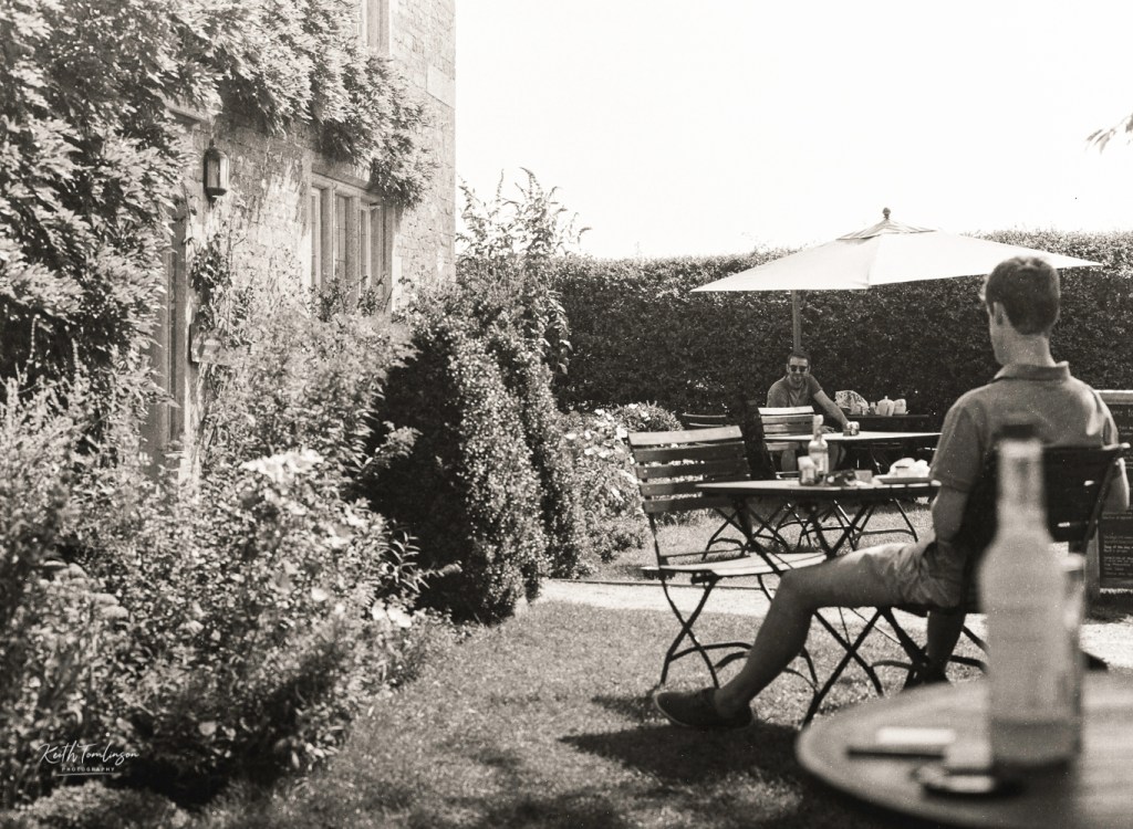 A photo of two men having lunch at a countryside cafe
