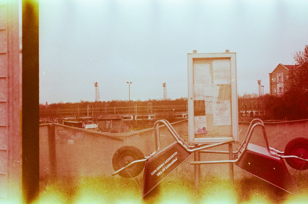 Wheelbarrows placed against a community board for use on the local allotments