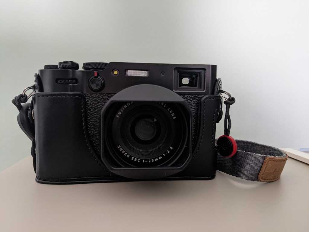 A photo of my X100V camera with the lens hood attached