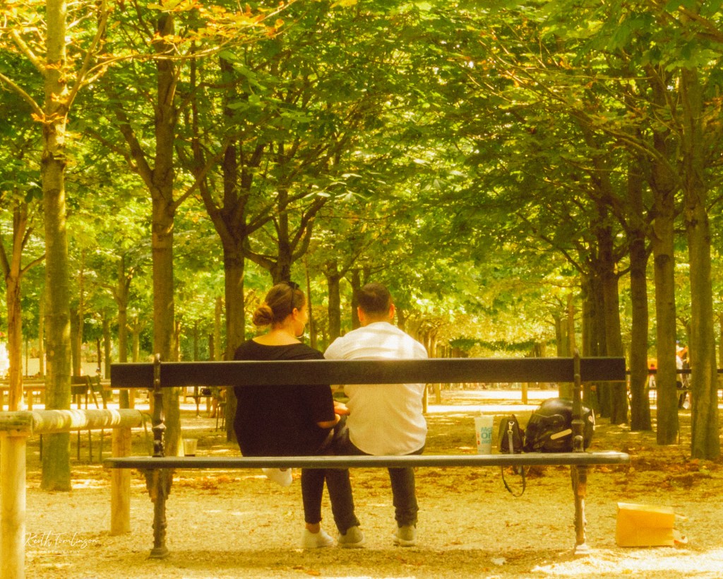 A young couple enjoy some spring sun in Jardin du Luxembourg, Paris