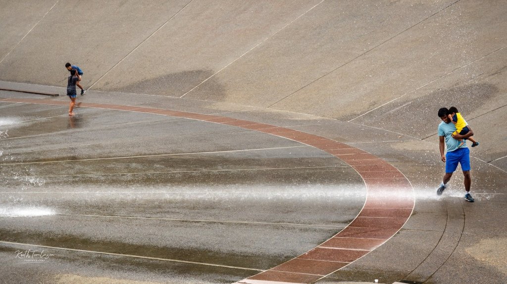 A father and son enjoy the International Fountain in Seattle. 
