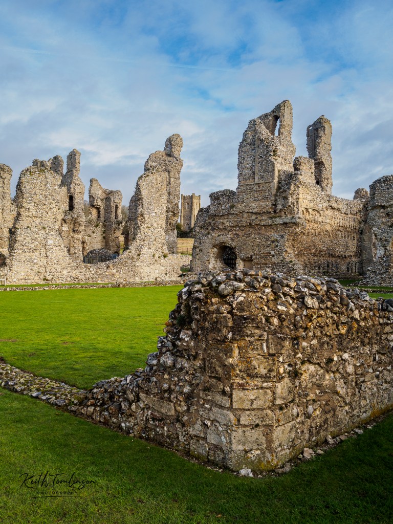 A view of the ruins of Castle Acre Priory looking towards the village church