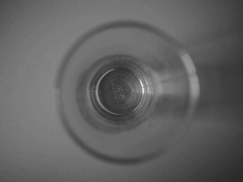 A photo of a tall glass from above looking down
